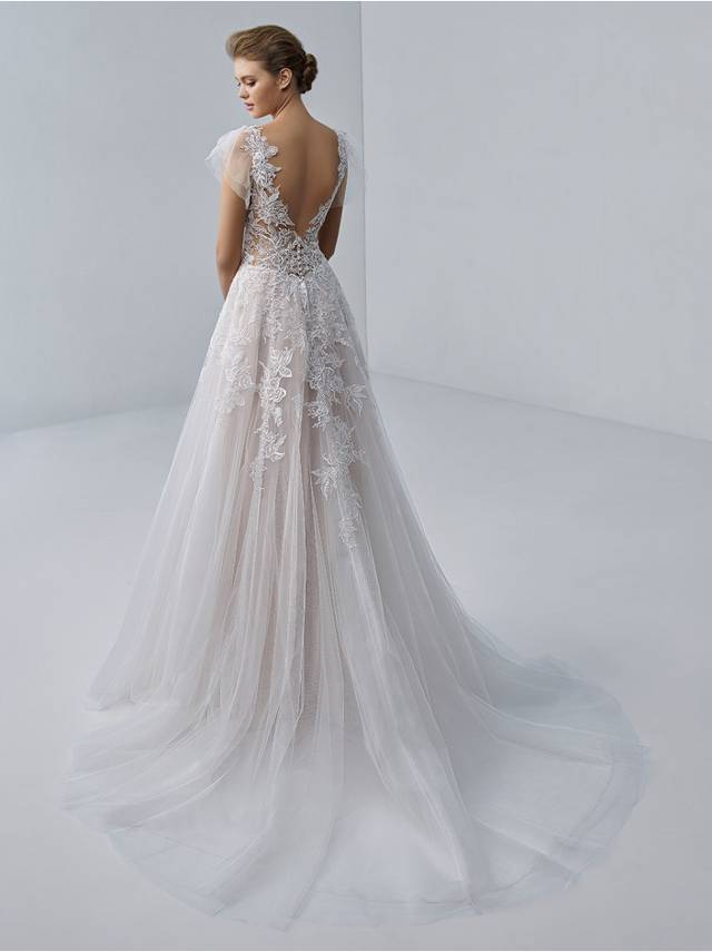 Code: Etoile Aimee - IN STUDIO Romantic and ethereal, this gown features flirty shoulder tulle detailing, a plunging illusion neckline, and exquisite floral embroidered lace atop soft organza and tulle.Colour Options: Ivory/Nude/Nude  OR   Ivory/Ivory/Nude
