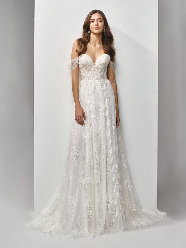 Code: Enzoani Beautiful BT19-07 Code: Enzoani Beautiful BT19-07 Modern form meets classic, romantic detailing in this full-length, A-line gown with a deep sweetheart neckline. The chantilly and sequin embroidered lace paired with soft, flowing tulle results in the sweetest of contemporary styles accented with delicate off-the-shoulder sleeves.Colour Options : Ivory/Beige Or Ivory/Ivory