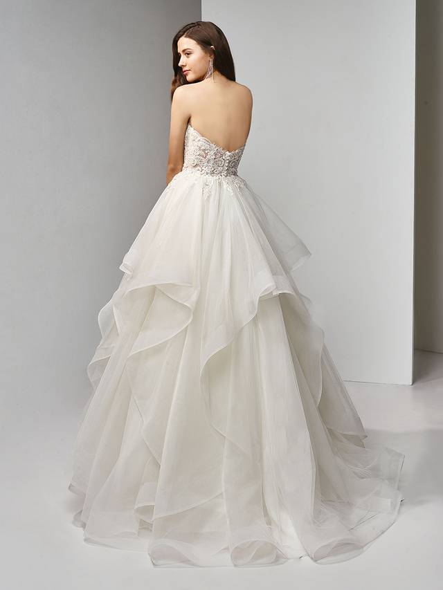 Code: Enzoani Beautiful BT19-09 Code: Enzoani Beautiful BT19-09 The ultimate A-line ball gown for any swoon-worthy moment. The strapless sweetheart neckline bodice is beautifully made of beaded, embroidered and chantilly lace.Specially placed lace appliques daintily drape onto the voluminous tiered, tulle skirt for an added dose of sweet and playful romance.Colour Options: Ivory/Beige OR Ivory/Ivory