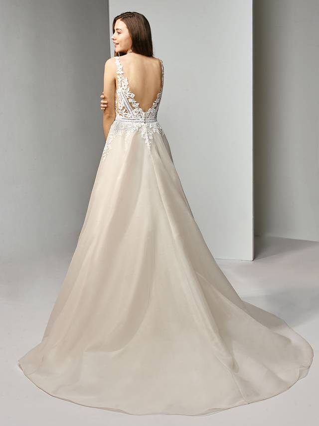 Code: Enzoani Beautiful BT19-11 Code: Enzoani Beautiful BT19-11 Modern and flirty, this A-line, organza gown is guaranteed to keep you the center of attention. The bodice features a dreamy, deep V-neckline accentuated with sweet embroidered lace. Crystal buttons adorn the low V-back for a sparkling finishing touch.Colour Options : Dark Ivory/Ivory/Nude Or Dark Ivory/Ivory/Ivory