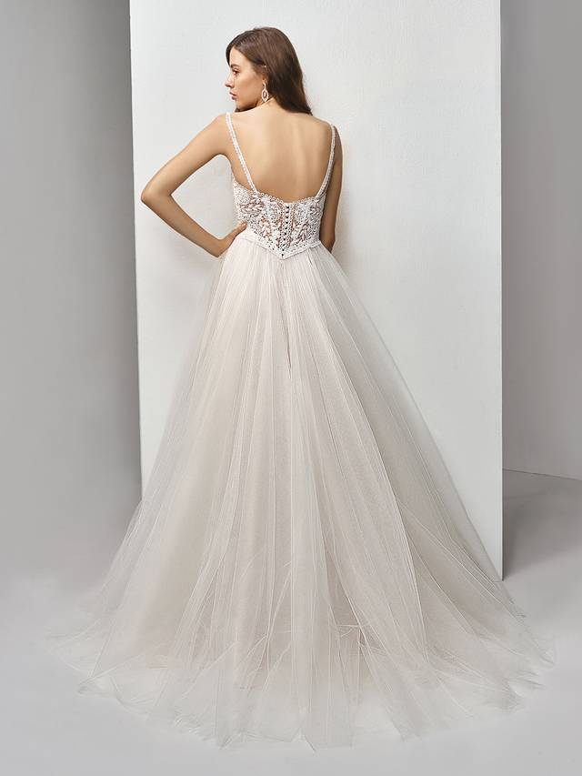 Code: Enzoani Beautiful BT19-16 Code: Enzoani Beautiful BT19-16 Effortlessly romantic, this full-length, A-line gown is a perfect modern fairytale dress. A skirt of flowing tulle layers creates the dreamiest effect to balance out the intricate embroidered lace on the bodice with a deep sweetheart neckline and delicate lace straps. A matching, low illusion back with covered buttons provides just the right touch of allure to finish the sweet look.Colour Options : Ivory/Latte OR Ivory/Ivory