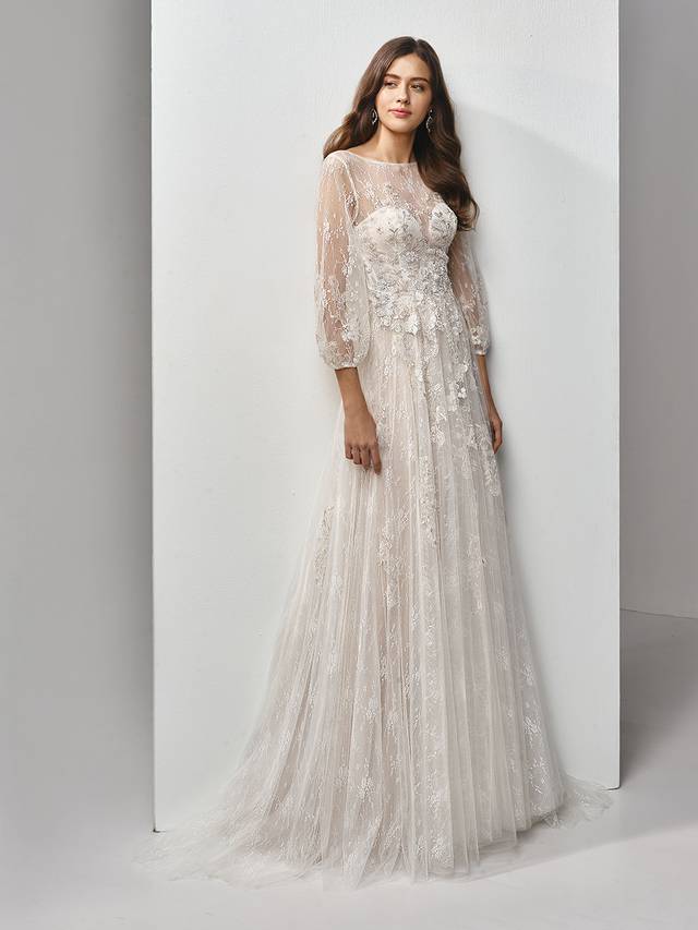 Code: Enzoani Beautiful BT19-18 Code: Enzoani Beautiful BT19-18 Talk about timeless. This full-length, A-line gown is classically gorgeous at every turn, with long lace and tulle bell sleeves for the perfect bohemian fairytale look. An illusion scoop over deep sweetheart neckline adds some modern sexiness, while embroidered lace and chantilly lace sprinkling down to the soft tulle skirt provides all the intricate detailing that will have your guests ooh-ing and aah-ing. The gorgeous low, open V-back is finished with covered buttons and an invisible zipper closure.Colour Options : Ivory/Pewter/Nude OR Ivory/Pewter/Ivory