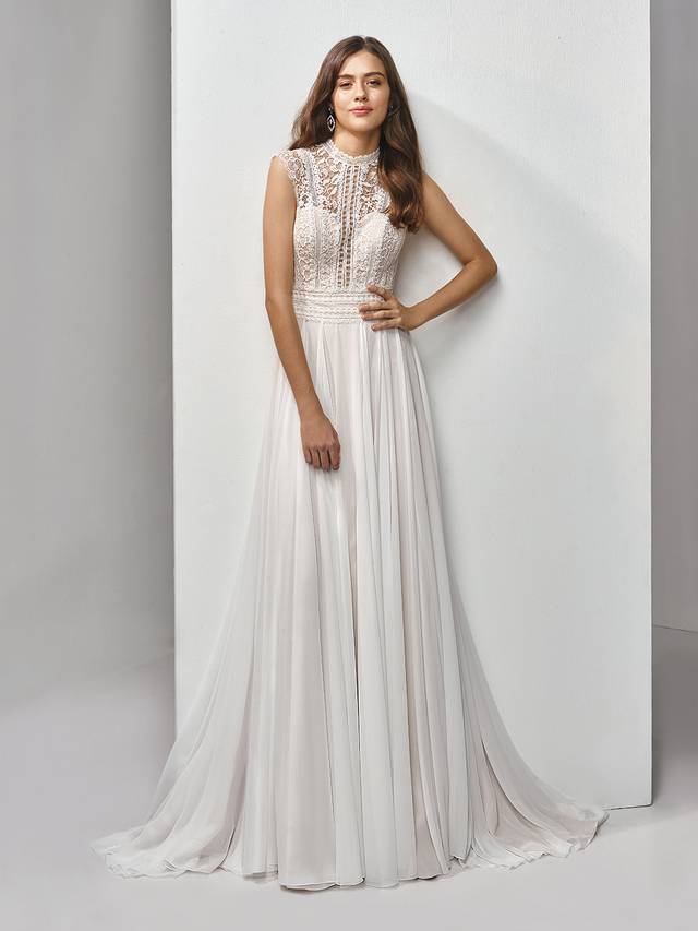 Code: Enzoani Beautiful BT19-19 Code: Enzoani Beautiful BT19-19 Feminine and romantic with vintage vibes and a boho feel -- this full-length, A-line gown features a striking bodice with exquisite eyelet lace with sweet floral motifs. A deep sweetheart neckline adds some modern sexiness to balance out the slightly high neck and cap sleeves. Light chiffon is a soft, dreamy complement to the bodice and matching illusion eyelet lace back with covered buttons and invisible zipper closure.Colour Options : Ivory/Latte OR Ivory/Ivory
