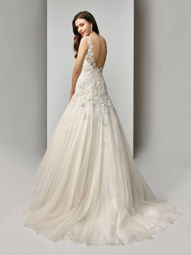 Code: Enzoani Beautiful BT19-23 Code: Enzoani Beautiful BT19-23 Utterly romantic. This full-length, modified A-line gown features intricately beaded, embroidered lace and cascading tulle layers. An illusion bateau over sweetheart neckline is romantically offset with a matching low, illusion V-back with covered buttons and an invisible zipper closure.Colour Options : Ivory/Beige/Pewter OR Ivory/Ivory/Pewter