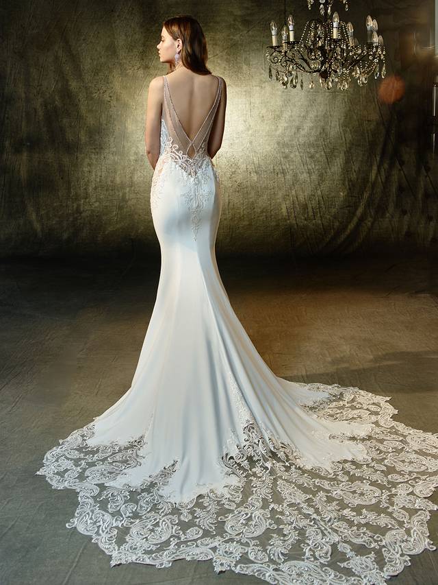 Code: Enzoani Blue Lena Code: Enzoani Blue Lena Sulty mermaid gown with the most exquisite beaded, embroidered lace sweetheart bodice. Dazzling rhinestones frame the deep, illusion V-back that also features the sweetest keyhole effect. Intricate lace flows from the gorgeous train and completes this mesmerizing gown.Collour Options : Ivory/Beige OR Ivory/Ivory