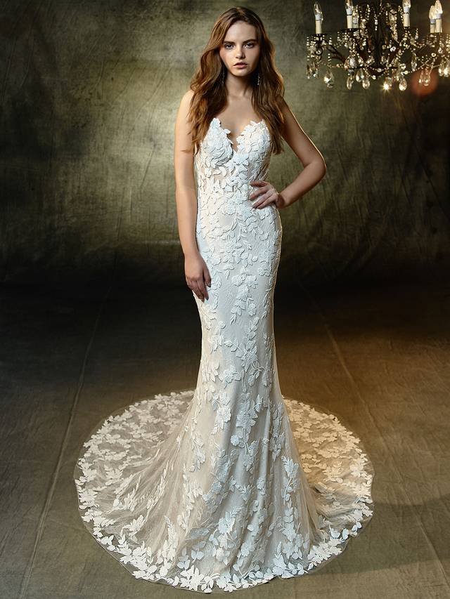 Code: Enzoani Blue Lesley Code: Enzoani Blue Lesley Step straight out of a floral fairytale dream and onto the aisle in this sweet mermaid gown with delicate spaghetti straps framing the sexy, deep sweetheart neckline. Intricate embroidered lace and chantilly lace appliques lightly layer over the softest tulle, creating an ethereally romantic look.Colour Options : Ivory/Sand OR Ivory/Ivory