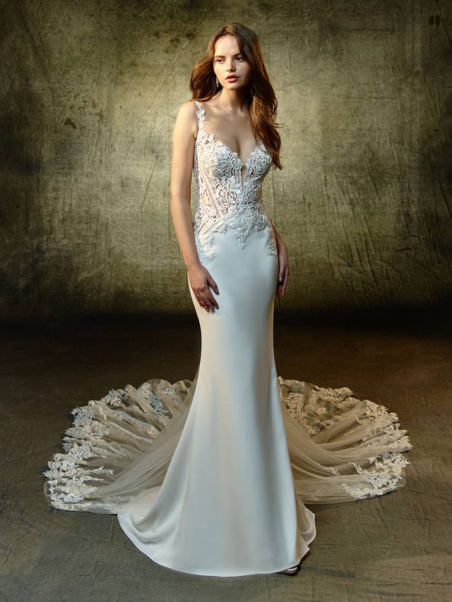 Code: Enzoani Blue Linda Code: Enzoani Blue Linda Stop everyone in their tracks with this stretch georgette, mermaid stunner. Delicate embroidered lace and ribbon lace adorn the illusion sweetheart bodice, straps, and complementary illusion back. A magnificent, matching illusion lace train ensures all eyes will be on you as you take the trip down the aisle.Colour Options : Ivory/Beige OR Ivory/Ivory