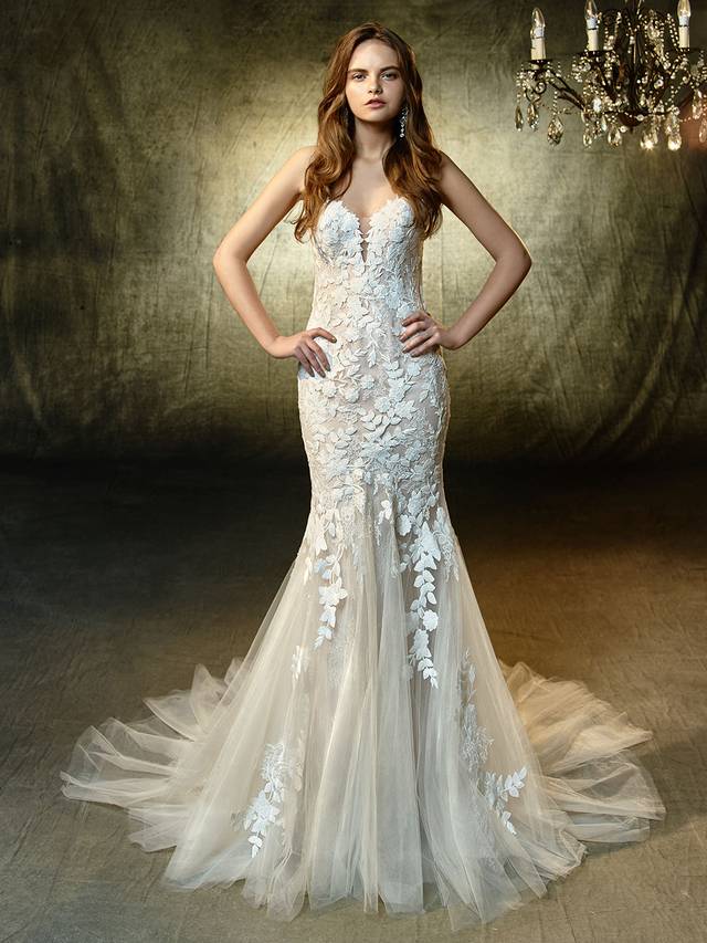 Code: Enzoani Blue Livie Code: Enzoani Blue Livie Picture-perfect and oh, so romantic. This full-length mermaid gown showcases a deep strapless sweetheart neckline bodice adorned with feminine, floral embroidered lace and chantilly lace that cascades down onto the soft tulle skirt. An invisible back zipper completes the lovely look.Colour Options : Ivory/Mocha OR Ivory/Ivory
