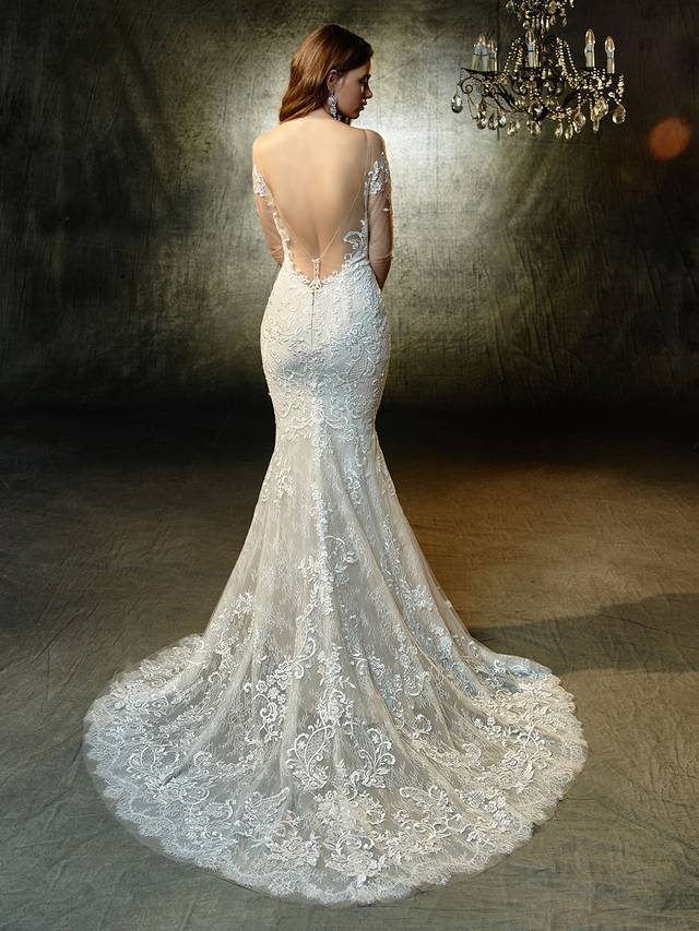 Code: Enzoani Blue Lonnie Code: Enzoani Blue Lonnie For the modern bride searching for a timeless, sophisticated look -- this full-length mermaid gown features elegant, long tulle sleeves embellished with sequin embroidered and chantilly lace. A matching deep sweetheart neckline bodice is perfect with a sexy, low illusion back adorned with crystal buttons and an invisible zipper.Colour Options : Ivory/Beige/Sand OR Ivory/Ivory