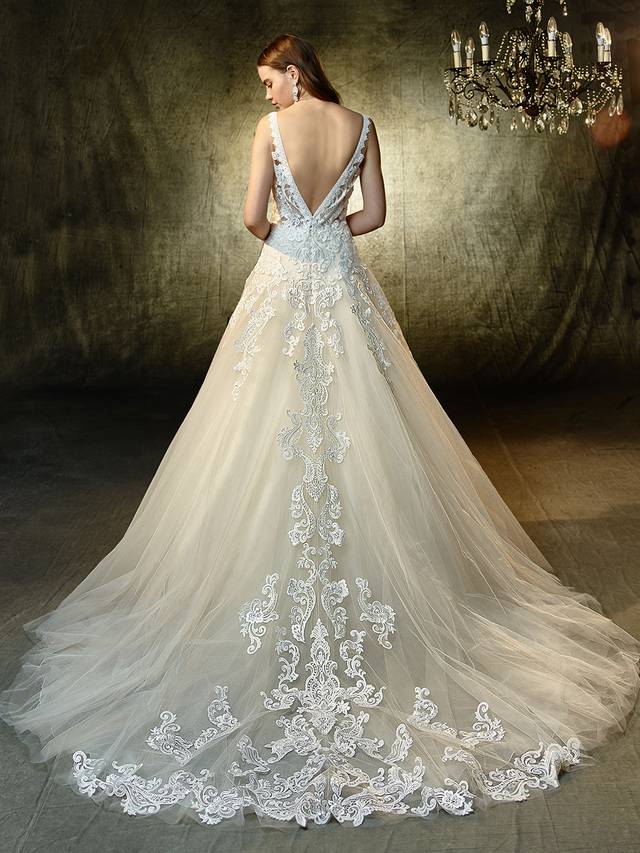 Code: Enzoani Blue Louella Code: Enzoani Blue Louella Sure to steal hearts, this full-length, A-line gown is modern, romantic, and enchanting all at once. Captivating sequin Venice lace adorns the plunging, illusion V-neck bodice and matching low V-back while cascading down the train of the dreamiest tulle skirt for a gorgeous waterfall effect. Crystal buttons and an invisible back zipper closure complete the stunning look.Colour Options : Ivory/Beige OR Ivory/Ivory