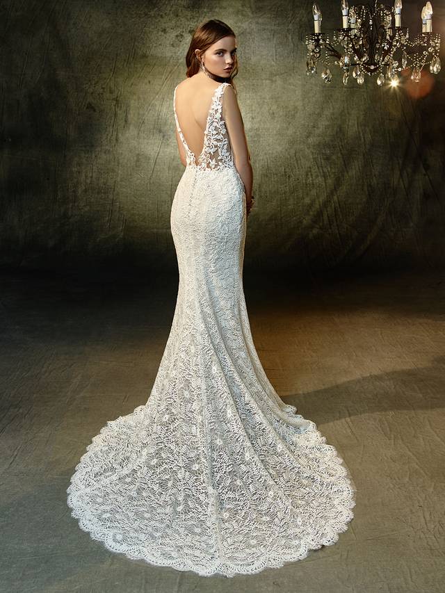 Code: Enzoani Blue Lucy Code: Enzoani Blue Lucy Lovely in lace -- this full-length mermaid gown is what romantic lace dress dreams are made of. A plunging illusion bodice with V-neckline extends to a low, illusion V-back that's sure to captivate all your guests. All-over, embroidered lace becomes an exquisite vision, with scalloped hem lace and an invisible back zipper closure providing the finishing touches.Colour Options : Ivory/Sand OR Ivory/Ivory
