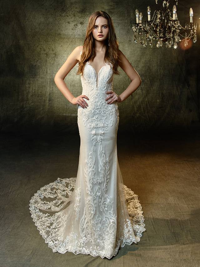 Code: Enzoani Blue Lunaire Code: Enzoani Blue Lunaire A gorgeously modern gown with vintage vibes and flair. This full-length mermaid gown features a plunging sweetheart neckline and illusion lace straps that extend into a breathtaking illusion keyhole back to keep everyone captivated as you come and go. Sequin, embroidered lace and delicate glitter tulle provides subtle, all-over sparkle while the spectacular scalloped hem lace train is guaranteed to be picture perfect.Colour Options : Ivory/Sand OR Ivory/Ivory