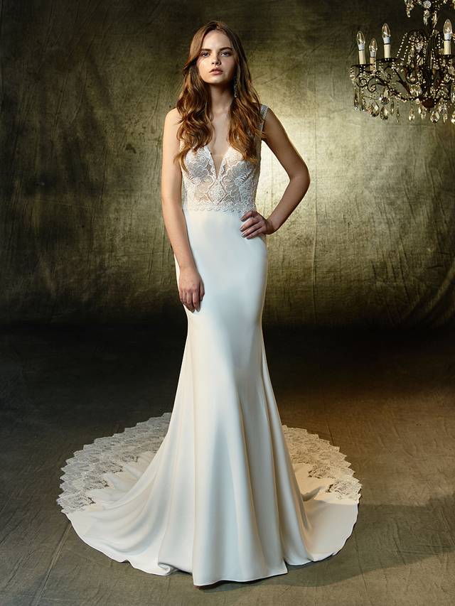 Code: Enzoani Blue Luz Code: Enzoani Blue Luz Chic, sleek, and sexy -- this full-length mermaid gown mixes the softest stretch georgette fabric with romantic beaded chantilly lace on the illusion bodice with plunging V-neckline and matching low, illusion V-back. A lace band at the waist softly cinches the figure and draws the eye down to the dazzling lace train. Finished with crystla buttons and an invisible back zipper closure.Colour Options : Ivory/Nude OR Ivory/Ivory