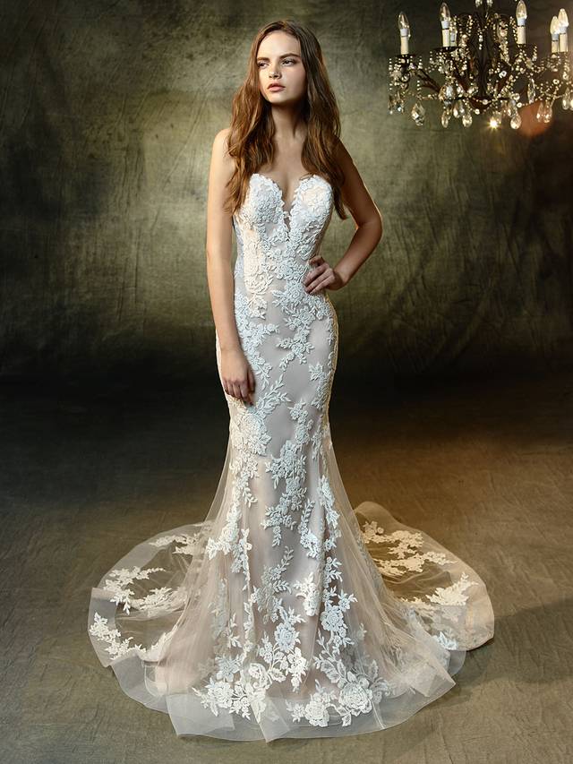 Code: Enzoani Blue Lyric Code: Enzoani Blue Lyric As sweet as a melody, Lyric features intricate embroidered lace embellishing a classic, plunging strapless sweetheart neckline and soft tulle mermaid skirt. Horsehair hem creates a modern, striking effect while an invisible back zipper closure completes the lovely look.Colour Options : Ivory/Latte OR Ivory/Ivory