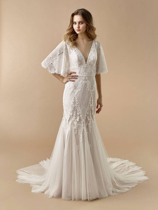 Code: Enzoani Beautiful BT20-05 Code: Enzoani Beautiful BT20-05 Perfect for the boho bride. This full-length mermaid gown is gorgeous at every turn with its fluttering, light lace sleeves and soft tulle skirt. A deep V-back adds a sexy, modern touch that is sure to captivate your guests. Covered buttons and an invisible zipper add final touches to this lovely look.Colour Options: Ivory/Latte OR Ivory/Ivory