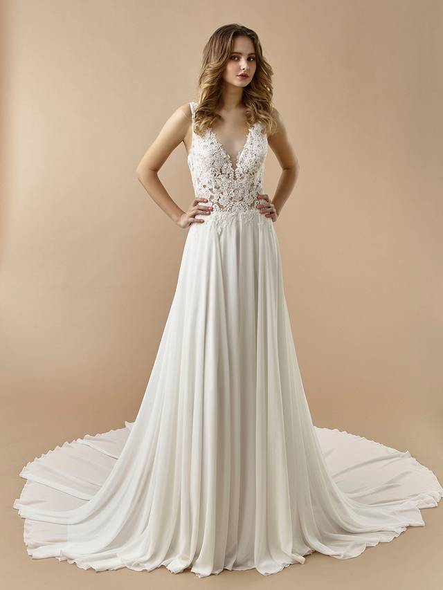 Code: Enzoani Beautiful BT20-06 Code: Enzoani Beautiful BT20-06 Simple, sleek, and oh-so-sweet. BT20-6 features all the classic elements of an A-line gown with its gorgeous lace bodice and airy chiffon skirt. It receives a sweet, modern twist with its low plunging back complete with adjustable criss-cross straps. Finished with covered buttons and an invisible zipper.Colour Options: Ivory