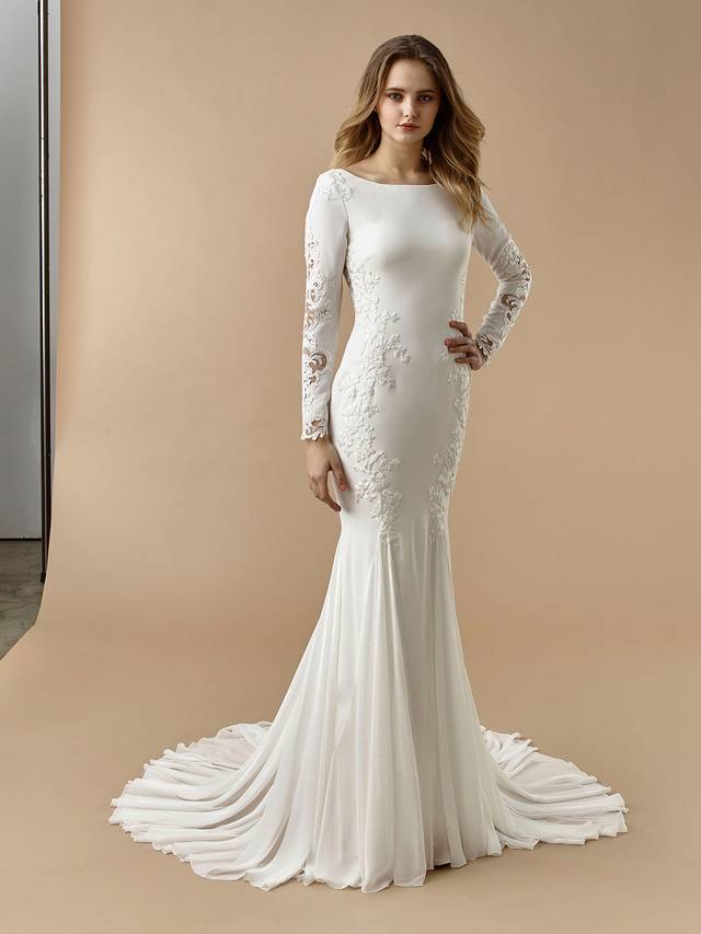 Code: Enzoani Beautiful BT20-11 Code: Enzoani Beautiful BT20-11 Vintage elegance meets modern glam in this gorgeous mermaid gown. Sleek but supportive stretch georgette is sure to hug all the right curves, while a bateau neckline keeps lines clean and complements the long lace sleeves. A jaw-dropping, low illusion lace back with covered buttons is sure to keep your guests entranced.Colour Options: Ivory/Nude OR Ivory/Ivory