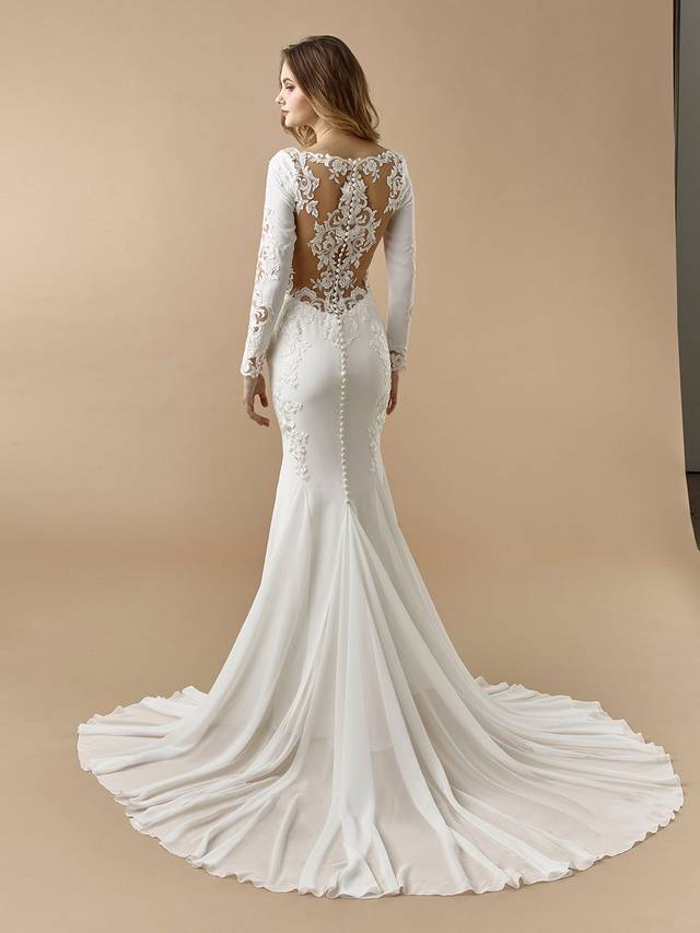 Code: Enzoani Beautiful BT20-11 Code: Enzoani Beautiful BT20-11 Vintage elegance meets modern glam in this gorgeous mermaid gown. Sleek but supportive stretch georgette is sure to hug all the right curves, while a bateau neckline keeps lines clean and complements the long lace sleeves. A jaw-dropping, low illusion lace back with covered buttons is sure to keep your guests entranced.Colour Options: Ivory/Nude OR Ivory/Ivory