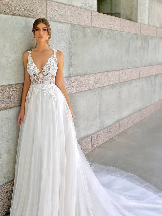 Code: Enzoani Beautiful BT20-26 - IN STUDIO Code: Enzoani Beautiful BT20-26 - IN STUDIO Sweet and feminine with all the right floral details. Large floral lace is showcased at the bodice as it leads to a jaw-dropping, beautiful low back. Soft layers of tulle at the skirt add to its whimsical enchantment. The lovely look is complete with lacy floral straps and covered buttons.Colour Options: Ivory/Beige OR Ivory/Ivory