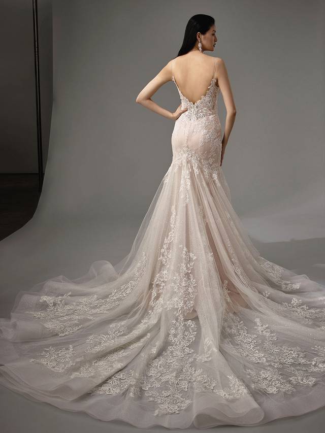Code: Enzoani Blue - Magnolia Code: Enzoani Blue - Magnolia Sweet and beautiful, just as the flower, this mermaid gown features a gorgeous train made of layers of mesmerizing glitter tulle and lace. More glitter lines the gown to give an extra pop effect. Chantlily lace is used throughout the gown to finish this enchanting look.Colour Options: Ivory/Latte/Nude OR Ivory/Ivory/Ivory OR Ivory/Ivory/Nude