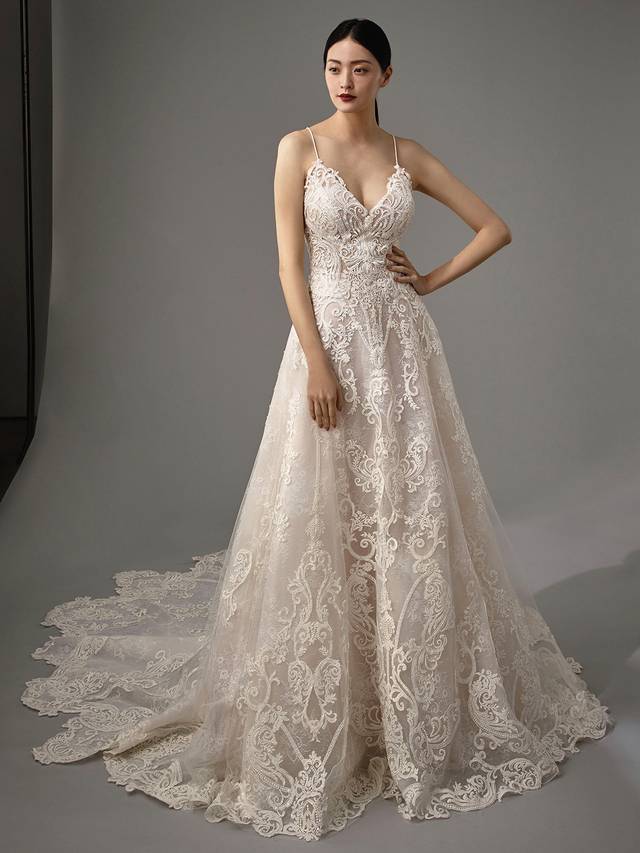 Code: Enzoani Blue - Manda Code: Enzoani Blue - Manda Chic, modern, feminine, this gown has it all. A V-neckline and all over regal lace are only the start as another lace layer is added below the skirt to give a 3D effect with movement. Straps criss-cross onto the back to create an alluring keyhole back with the most decadent lace design all the way through to the train.Colour Options: Ivory/Latte OR Ivory/Ivory