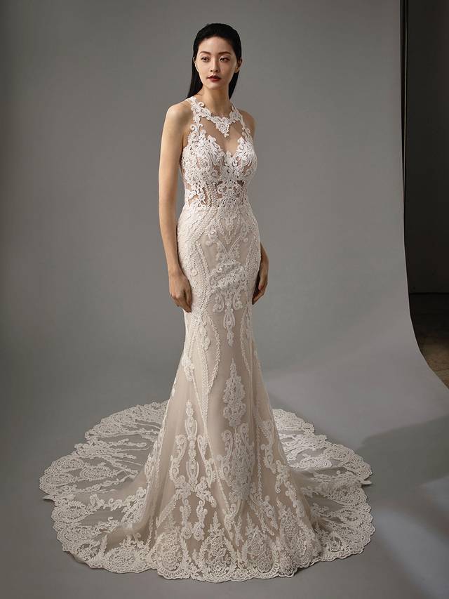 Code: Enzoani Blue - Marci Code: Enzoani Blue - Marci Blink and you'll miss. This mermaid gown offers a whimsical illusion neckline and back. Regal lace is carefully placed at the neck with just enough room between the traditional sweetheart neckline for a playful, sultry effect. More lace is meticulously added to the gown's jaw-dropping illusion, low-plunging back as it finishes with covered buttons along the spine. Colour Options: Ivory/Sand/Nude OR Ivory/Ivory/Ivory OR Ivory/Ivory/Nude OR Ivory/Nude/Nude