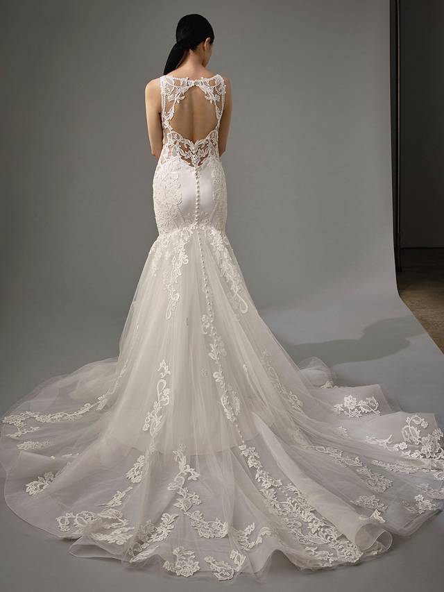 Code: Enzoani Blue - Maribel Code: Enzoani Blue - Maribel Ethereal with an air of modern chic. Flatter any figure with this mermaid gown's lateral lace illusion panels. Gorgeous chantlily lace is placed upon soft crepe with a skirt layered with the softest tulle. A lacy keyhole back adds an edgy feel, complemented by covered buttons trailing to the hem of a dreamy train.Colour Options: Ivory/Nude OR Ivory/Ivory