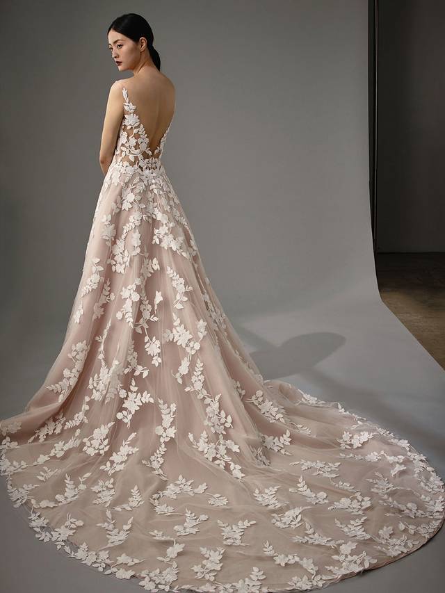 Code: Enzoani Blue - Marie Code: Enzoani Blue - Marie Simplicity at its finest. Gorgeous floral motifs are the centre of this A-line gown as they cover every inch. A sultry, low V-neck and back add to Marie's captivating lace to leave your guests speechless as you walk down the aisle.Colour Options: Ivory/Latte/Nude OR Ivory/Ivory/Ivory OR Ivory/Ivory/Nude