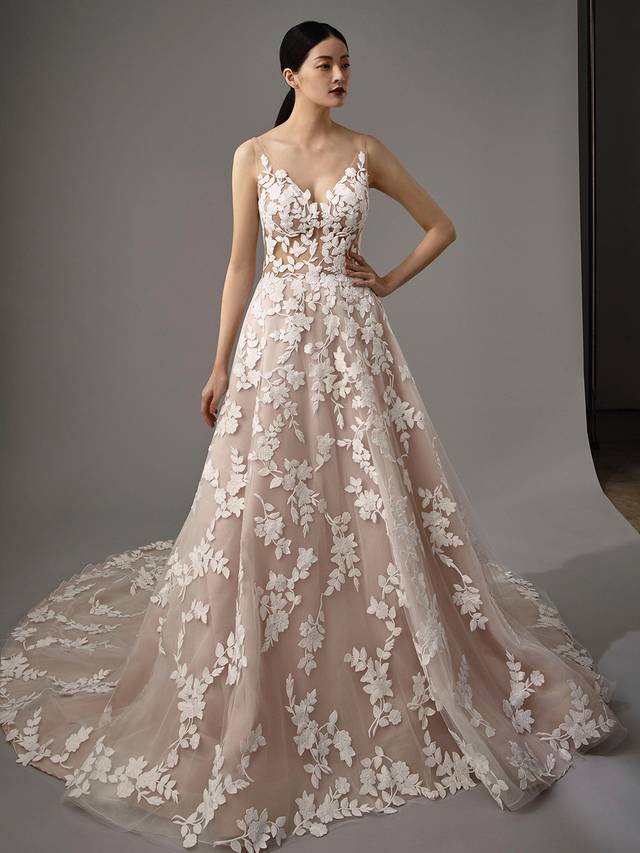 Code: Enzoani Blue - Marie Code: Enzoani Blue - Marie Simplicity at its finest. Gorgeous floral motifs are the centre of this A-line gown as they cover every inch. A sultry, low V-neck and back add to Marie's captivating lace to leave your guests speechless as you walk down the aisle.Colour Options: Ivory/Latte/Nude OR Ivory/Ivory/Ivory OR Ivory/Ivory/Nude