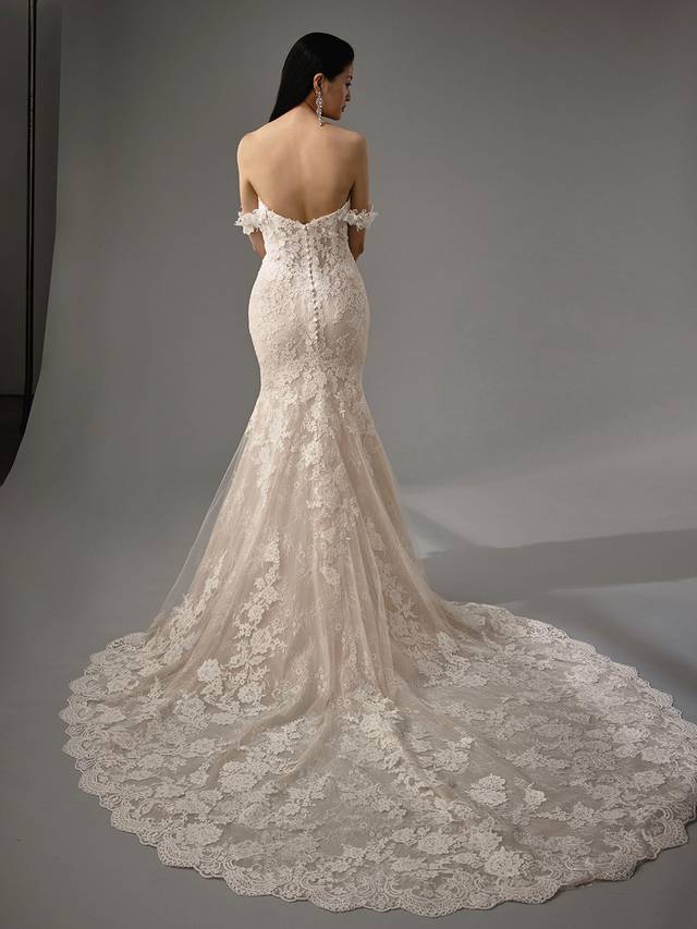 Code: Enzoani Blue - Marija Code: Enzoani Blue - Marija Ethereal and whimsical elements are all crafted into one gown. With its mermaid silhouette and gorgeous tulle train, Marija is sure to captivate all eyes. Chantlily lace is placed throughout the gown with detachable floral, off-shoulder sleeves. This look is finished with covered buttons for a completely romantic look.Colour Options: Ivory/Beig OR Ivory/Ivory