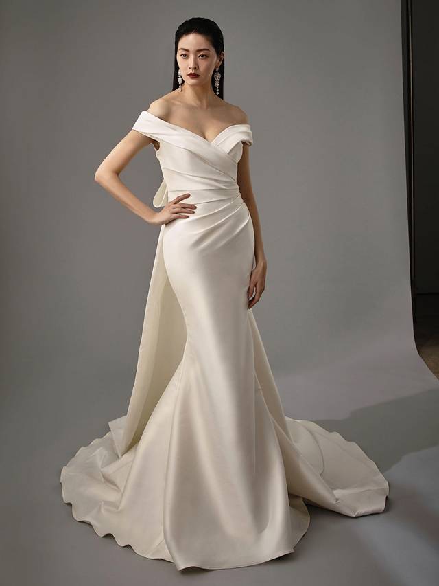 Code: Enzoani Blue - Marla Code: Enzoani Blue - Marla Feminine and elegant are all wrapped into one gown. Soft stretch mikado is gorgeously crafted to create this off-shoulder mermaid gown. A sweetheart neckline and ruched fabric at the side both flatters and enhances. Final touches are added with the gown's detachable statement bow. Colour Options: Ivory