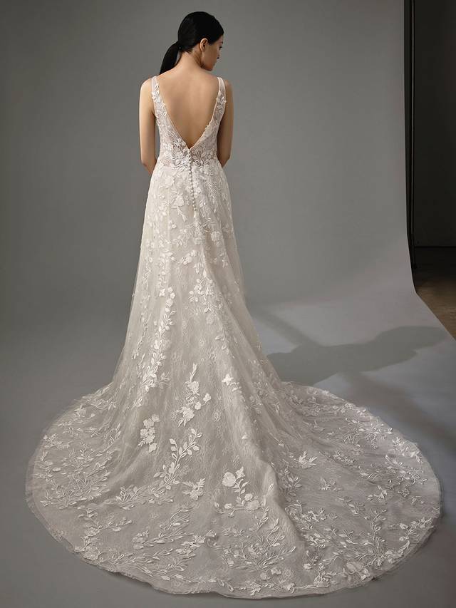Code: Enzoani Blue - Marlyssa Code: Enzoani Blue - Marlyssa Ethereal and romantic, gorgeous lace appliques cascade from the bodice to Marlyssa's soft tulle train. This A-line gown features a sultry low V-neck and sweet lacy bodice. The back is finished with a low V-cut and covered buttons.Colour Options: Ivory/Sand/Nude OR Ivory/Ivory/Ivory OR Ivory/Ivory/Ivory
