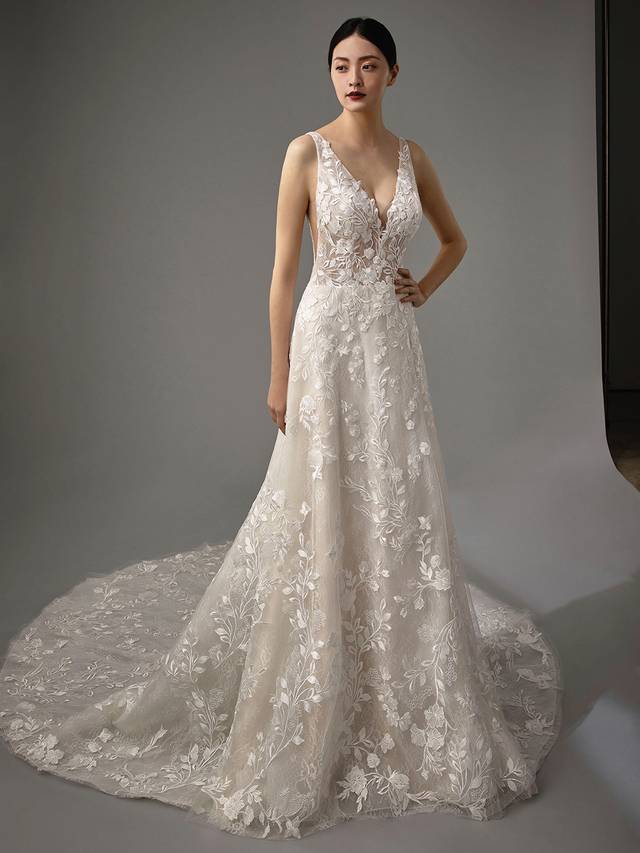 Code: Enzoani Blue - Marlyssa Code: Enzoani Blue - Marlyssa Ethereal and romantic, gorgeous lace appliques cascade from the bodice to Marlyssa's soft tulle train. This A-line gown features a sultry low V-neck and sweet lacy bodice. The back is finished with a low V-cut and covered buttons.Colour Options: Ivory/Sand/Nude OR Ivory/Ivory/Ivory OR Ivory/Ivory/Ivory