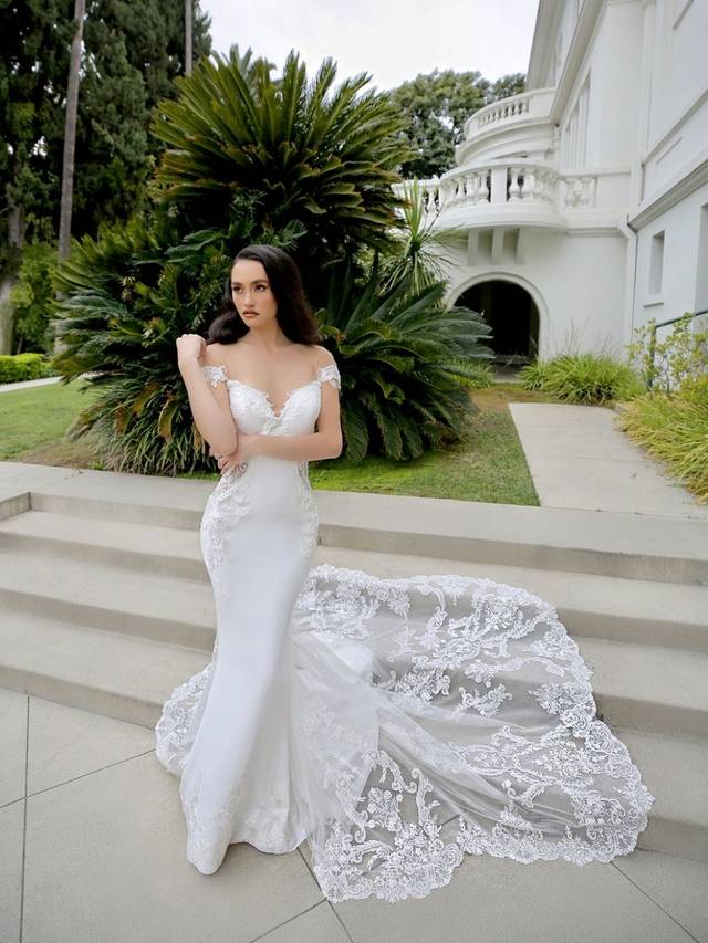 Code: Enzoani Blue - Marquise - IN STUDIO Code: Enzoani Blue - Marquise - IN STUDIO Elegance and romance are packed into one gorgeous stretch georgette gown. Alluring lace illusion panels on the sides are sure to highlight a bride's figure. Lace is carefully placed on the sweetheart neckline as it trails to the thigh. An alluring, low illusion back finishes the look with covered buttons cascading to the train's hem.Colour Options: Ivory/Nude OR Ivory/Ivory