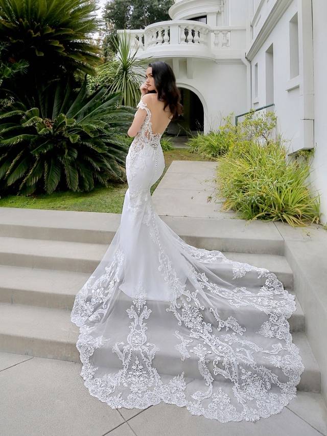 Code: Enzoani Blue - Marquise - IN STUDIO Code: Enzoani Blue - Marquise - IN STUDIO Elegance and romance are packed into one gorgeous stretch georgette gown. Alluring lace illusion panels on the sides are sure to highlight a bride's figure. Lace is carefully placed on the sweetheart neckline as it trails to the thigh. An alluring, low illusion back finishes the look with covered buttons cascading to the train's hem.Colour Options: Ivory/Nude OR Ivory/Ivory