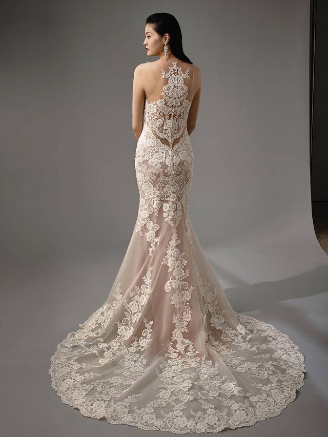 Code: Enzoani Blue - Matilda Code: Enzoani Blue - Matilda Mesmerize with this mermaid gown's jaw-dropping illusion back. Lace is carefully placed throughout the gown for added regality while crystal buttons trail down the back for a subtly elegant finishing touch. Complete with a dazzling tulle skirt.Colour Options: Ivory/Nude/Nude OR Ivory/Ivory/Ivory OR Ivory/Ivory/Nude OR Ivory/Sand/Nude