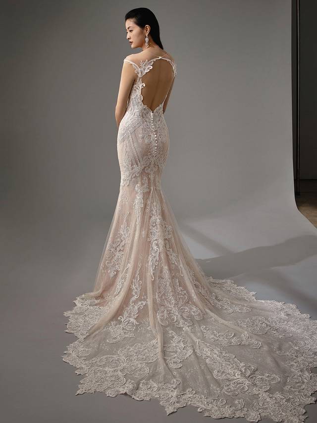 Code: Enzoani Blue - Mckenna Code: Enzoani Blue - Mckenna All-over lace and a plunging sweetheart neckline create a sultry mermaid gown. Geometric patterns at the side of the gown highlight the bride's waist while a romantic illusion keyhole back and covered buttons complete the look.Colour Options: Ivory/Latte/Nude OR Ivory/Ivory/Ivory OR Ivory/Ivory/Nude