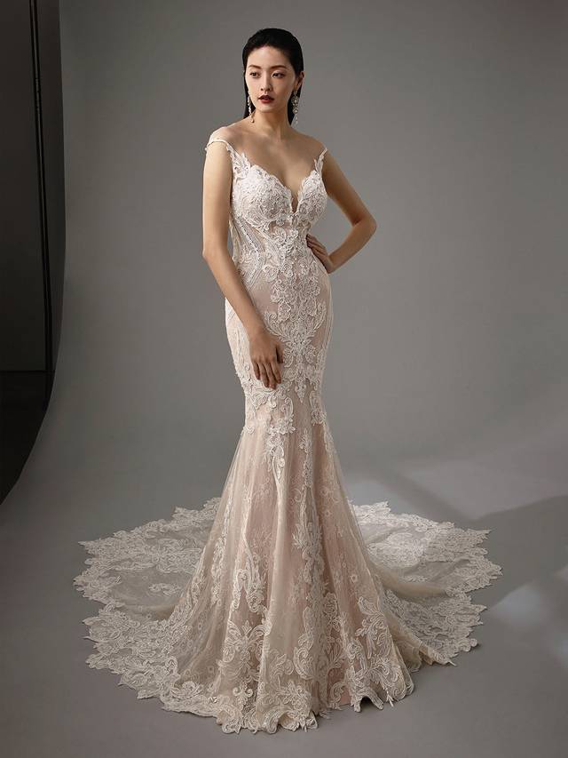 Code: Enzoani Blue - Mckenna Code: Enzoani Blue - Mckenna All-over lace and a plunging sweetheart neckline create a sultry mermaid gown. Geometric patterns at the side of the gown highlight the bride's waist while a romantic illusion keyhole back and covered buttons complete the look.Colour Options: Ivory/Latte/Nude OR Ivory/Ivory/Ivory OR Ivory/Ivory/Nude