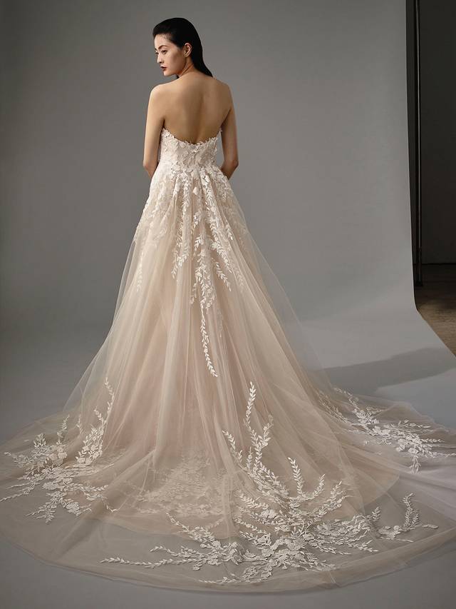 Code: Enzoani Blue - Meg Code: Enzoani Blue - Meg With this two-in-one gown, change from a sultry mermaid silhouette to dreamy A-line in seconds. Gorgeous floral lace appliques line the bodice and skirt. A strapless sweetheart neckline is supported by the bodice's built-in corset. Dreamy, soft tulle layers of the detachable train finish the ultimate romantic look.Colour Options: Ivory/Beig OR Ivory/Ivory
