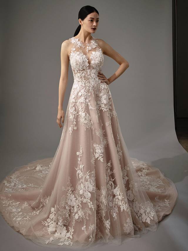 Code: Enzoani Blue - Michelle Code: Enzoani Blue - Michelle Romantic, dreamy, feminine - need we say more? Gorgeous lace details are placed on this A-line gown's illusion sweetheart neckline. Floral lace cascades from the bodice to the lush tulle layers of the skirt and train. An illusion back with the most exquisite lace finishes the gown with delicate crystal buttons trailing down the spine.Colour Options: Ivory/Mocha/Nude OR Ivory/Ivory/Ivory OR Ivory/Ivory/Nude
