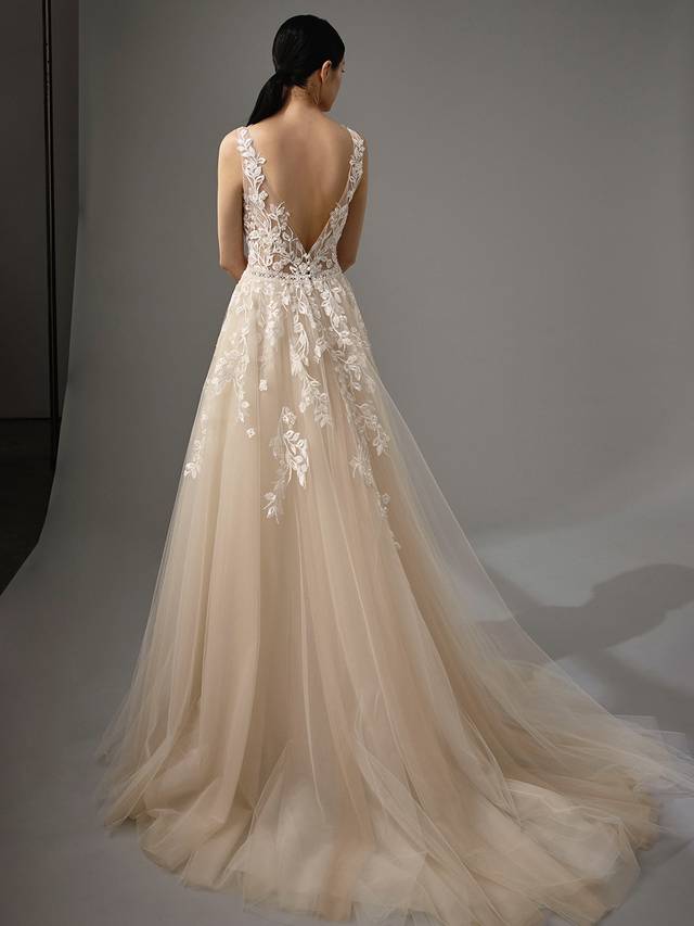 Code: Enzoani Blue - Mikayla Code: Enzoani Blue - Mikayla Sweet and ethereal, this A-line gown features a plunging neckline on a gorgeous chantilly lace bodice. Lace continues to cascade gently onto dreamy tulle layers of the skirt. Whimsical and romantic, Mikayla also features an open V-back with covered buttons and an invisible zipper closure.Colour Options: Ivory/Beige/Nude OR Ivory/Ivory/Ivory OR Ivory/Ivory/Nude