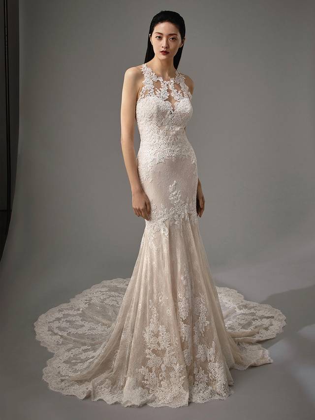 Code: Enzoani Blue - Miller Code: Enzoani Blue - Miller Romantic and elegant, this mermaid gown ensures all eyes will be on the bride. Gorgeous overlace adorns the illusion sweetheart neckline, trailing to the bodice and skirt. Delicate straps criss-cross over the back to create an eye-catchingl keyhole back. A sweet statement train and covered buttons complete the look.Colour Options: Ivory/Sand OR Ivory/Ivory OR Ivory/Nude