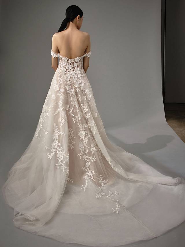 Code: Enzoani Blue - Misti Code: Enzoani Blue - Misti Give the illusion of walking on air with this A-line gown's lush, delicate layers of tulle. Detachable off-the-shoulder sleeves and a sweetheart neckline are added for an extra romantic effect. Stunning 3D floral motifs are added throughout the lace for extra special final touches.Colour Options: Ivory/Latte/Nude OR Ivory/Ivory/Ivory OR Ivory/Ivory/Nude