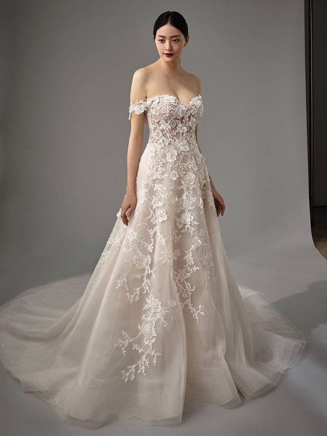 Code: Enzoani Blue - Misti Code: Enzoani Blue - Misti Give the illusion of walking on air with this A-line gown's lush, delicate layers of tulle. Detachable off-the-shoulder sleeves and a sweetheart neckline are added for an extra romantic effect. Stunning 3D floral motifs are added throughout the lace for extra special final touches.Colour Options: Ivory/Latte/Nude OR Ivory/Ivory/Ivory OR Ivory/Ivory/Nude
