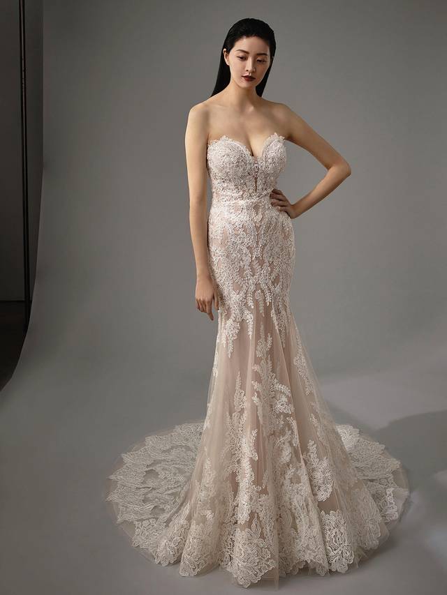 Code: Enzoani Blue - Monique Code: Enzoani Blue - Monique Dreamy and alluring, this mermaid gown is sure to have heads turning. All-over lace and a curve-hugging silhouette with a plunging sweetheart neckline are sure to be a winning combination. Delicate crystal buttons finish this timeless look.Colour Options: Ivory/Beige/Nude OR Ivory/Ivory/Ivory OR Ivory/Ivory/Nude