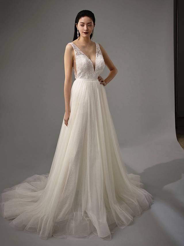 Code: Enzoani Blue - Myelle with Overskirt Code: Enzoani Blue - Myelle with Overskirt Take this look from sweet and whimsical to modern boho in seconds. This two-in-one piece changes from an A-line gown to edgy jumpsuit. Soft, airy layers of tulle can be added just by attaching the skirt onto the jumpsuit, while the jumpsuit itself offers a plunging neckline and sweet ribbon belt at the waist.Colour Options: Ivory/Sand OR Ivory/Ivory OR Ivory/Nude