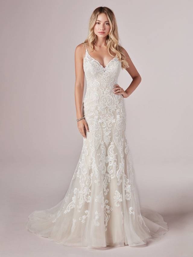 Code: Rebecca Ingram - Adelaide - IN STUDIO Code: Rebecca Ingram - Adelaide - IN STUDIO Go full beach mode in this romantic mermaid wedding dress. (Even the lace motifs look like seashells and sunset waves!)Lace motifs over tulle. Beaded lace motif bodice. llusion V-back. V-neckline. Beaded spaghetti straps. Lined with Orlando satinColour Options: All Ivory OR Ivory Over Soft Blush
