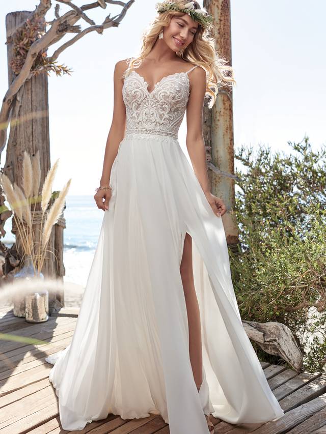 Code: Rebecca Ingram - Lorraine - IN STUDIO Hot dang-soft and dreamy makes a major statement in this beaded V-neck chiffon sheath wedding dress in a slimming silhouette. (Plus it's light and breathable for all kinds of weather).Colour Options: Ivory