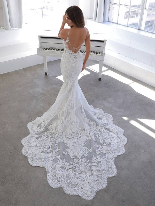 Code: Enzoani Blue Nini - IN STUDIO Code: Enzoani Blue Nini - IN STUDIO For the bride who wants to blend classic elegance with contemporary sexiness -- NINI features vintage floral embroidered lace and chantilly lace all over a curve-hugging mermaid silhouette with a dramatic, ornate train. A soft layer of glitter tulle adds subtle sparkle along with a delicately beaded back neckline accented with a playful keyhole effect.Colour Options: Ivory/Sand/Nude OR Ivory/Ivory/Ivory OR Ivory/Ivory/Nude OR Ivory/Nude/Nude