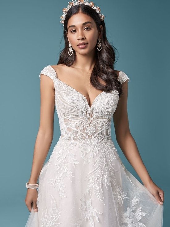 Code: Rebecca Ingram - Trina - IN STUDIO This unique floral lace A-line wedding dress is designed for any and all magical fairytale venues. Enchanted forest? European castle? Moonlit garden? You might as well book them all. Colour Options: Ivory over Misty Mauve OR Antique Ivory 